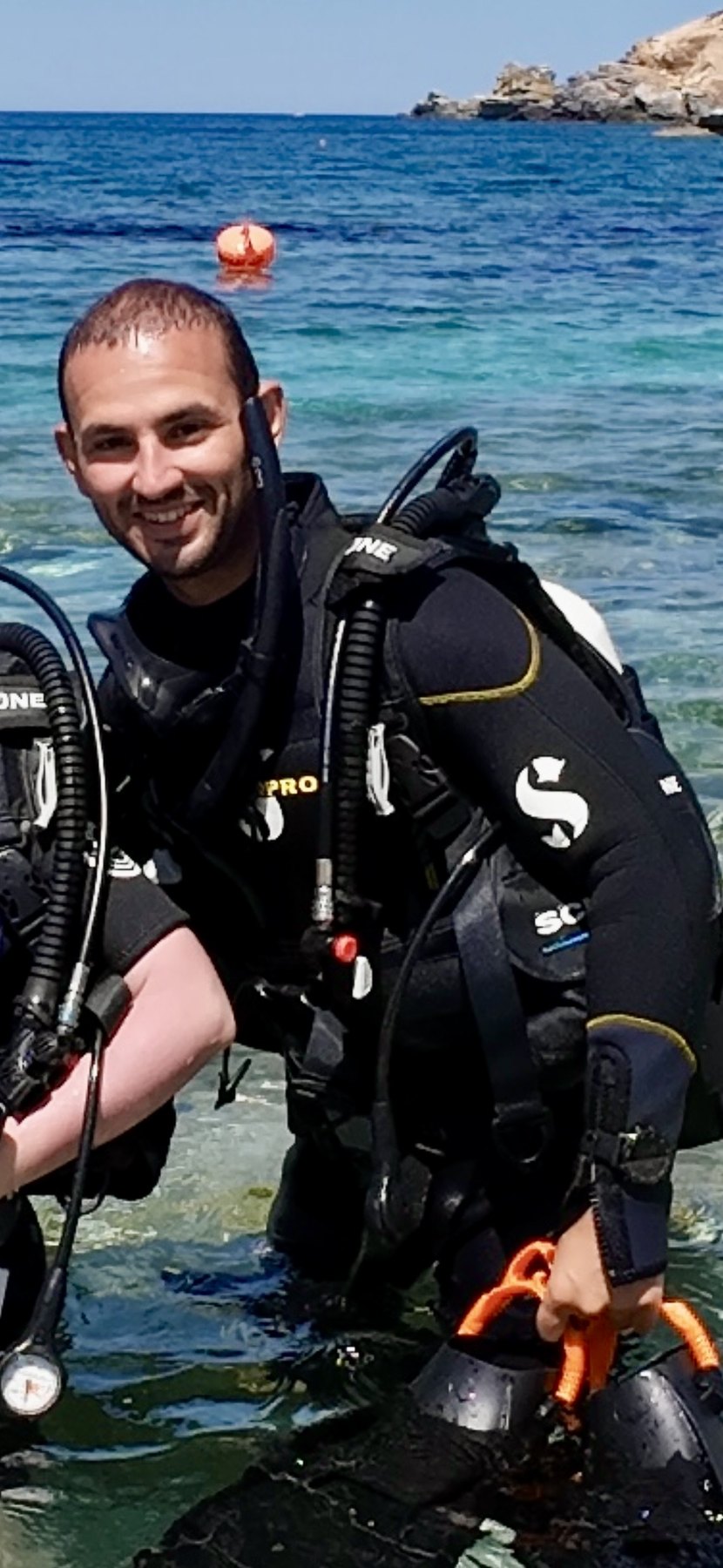 Dimitrios V. Smirnich in scuba equipment at the water's edge